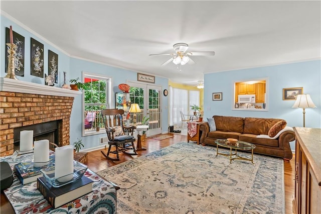 5584 Northwoods Rd, Clermont, GA 30527 - living room with ceiling fan, a fireplace, wood finished floors, and ornamental molding