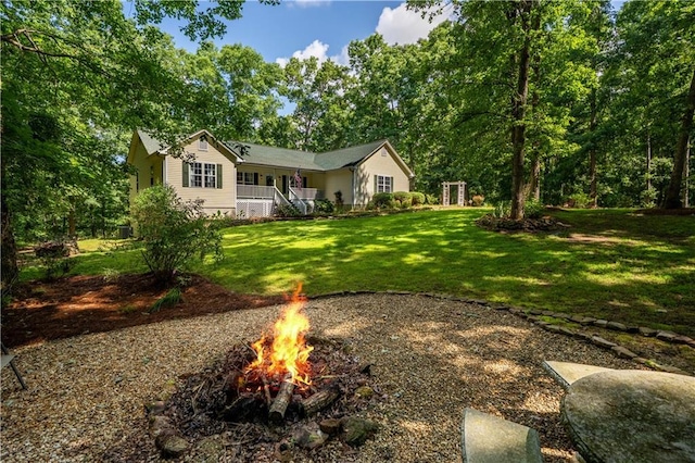 5584 Northwoods Rd, Clermont, GA 30527 - view of front of home featuring an outdoor fire pit, a front yard, and a porch