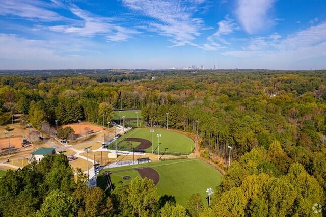 birds eye view of property featuring a view of trees