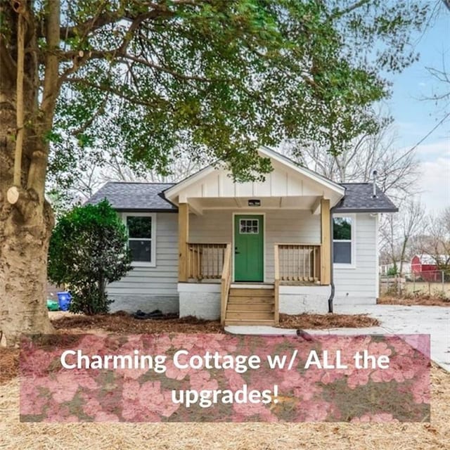 bungalow-style house with board and batten siding, covered porch, driveway, and a shingled roof