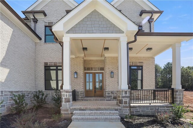 1525 Tapestry Rdg, Lawrenceville, GA 30045 - entrance to property with a porch, brick siding, and french doors