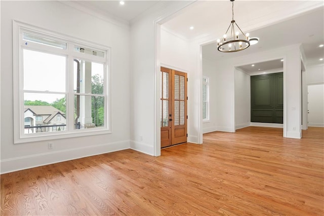 1525 Tapestry Rdg, Lawrenceville, GA 30045 - empty room featuring baseboards, ornamental molding, light wood-style floors, and a chandelier