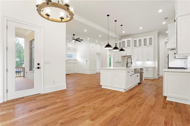 1525 Tapestry Rdg, Lawrenceville, GA 30045 - kitchen with open floor plan, light countertops, white cabinets, a sink, and ceiling fan with notable chandelier