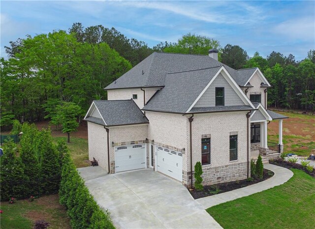 1525 Tapestry Rdg, Lawrenceville, GA 30045 - view of front of house featuring a chimney, a front yard, roof with shingles, concrete driveway, and an attached garage