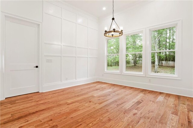 1525 Tapestry Rdg, Lawrenceville, GA 30045 - unfurnished dining area featuring an inviting chandelier, light wood-style floors, and a healthy amount of sunlight