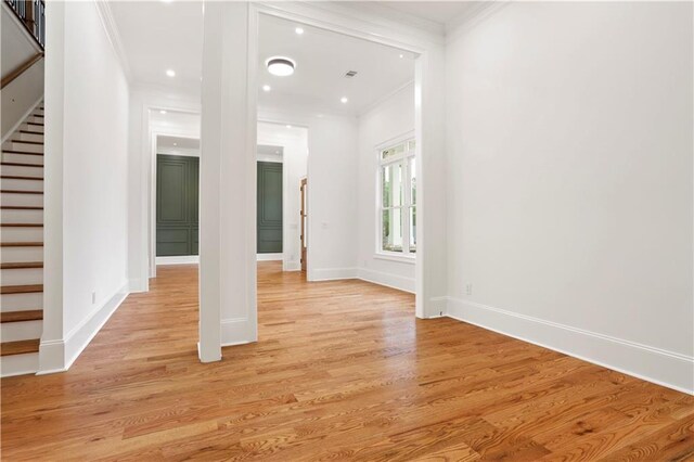 1525 Tapestry Rdg, Lawrenceville, GA 30045 - unfurnished living room with crown molding, baseboards, stairway, and light wood-style floors
