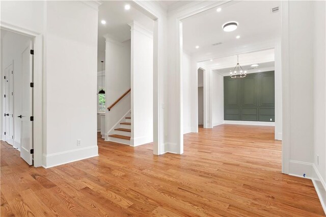 1525 Tapestry Rdg, Lawrenceville, GA 30045 - hall featuring ornamental molding, stairs, baseboards, light wood finished floors, and a notable chandelier