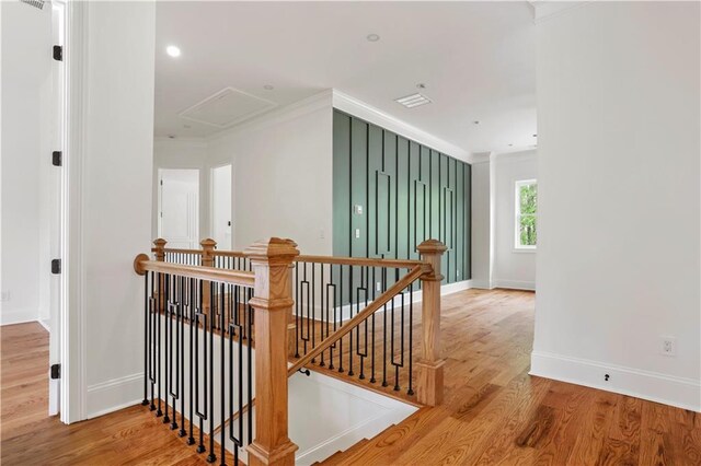 1525 Tapestry Rdg, Lawrenceville, GA 30045 - stairway featuring baseboards, attic access, wood finished floors, and ornamental molding