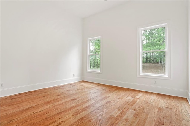 1525 Tapestry Rdg, Lawrenceville, GA 30045 - unfurnished room featuring baseboards, light wood finished floors, and a wealth of natural light