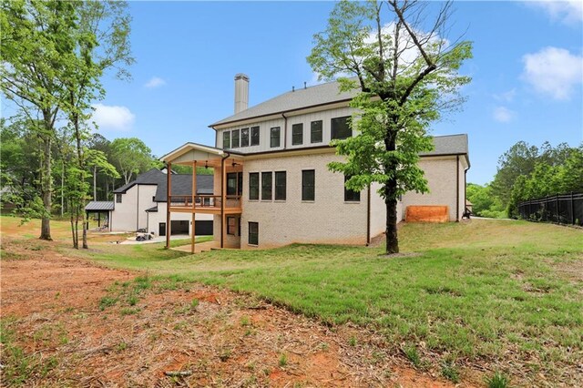 1525 Tapestry Rdg, Lawrenceville, GA 30045 - back of property with a lawn, brick siding, and a chimney