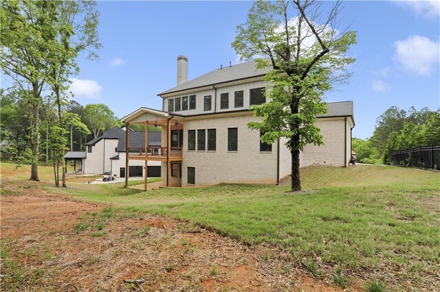 1525 Tapestry Rdg, Lawrenceville, GA 30045 - back of property with a chimney, a yard, and brick siding