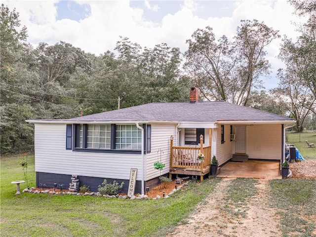 view of front of house with a front lawn and a carport