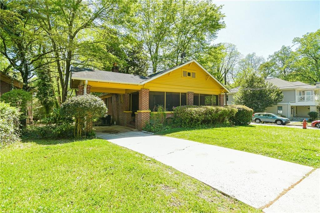 ranch-style house with a carport and a front yard