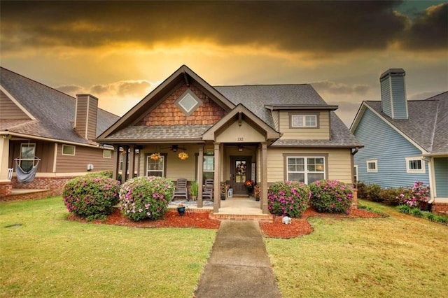 craftsman-style home featuring a yard and a porch