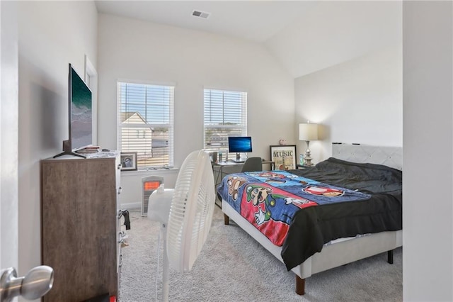 bedroom featuring vaulted ceiling, carpet, and visible vents