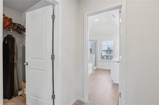 hall featuring baseboards
