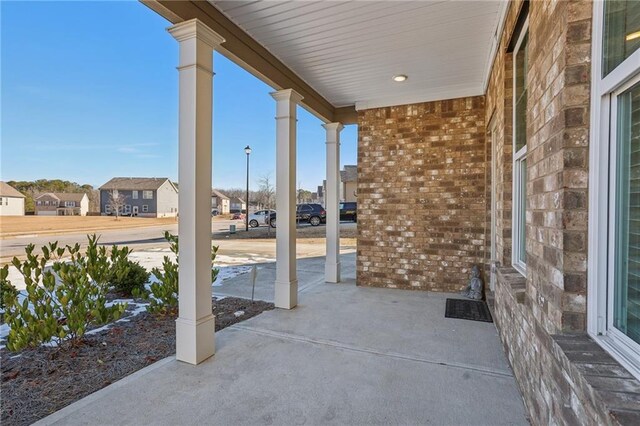 view of front of house with covered porch, a garage, and central AC