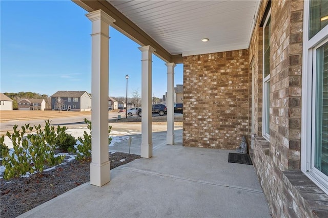 view of patio / terrace featuring a residential view and a porch