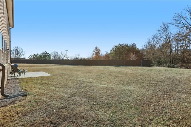 back of house with a lawn and a patio area