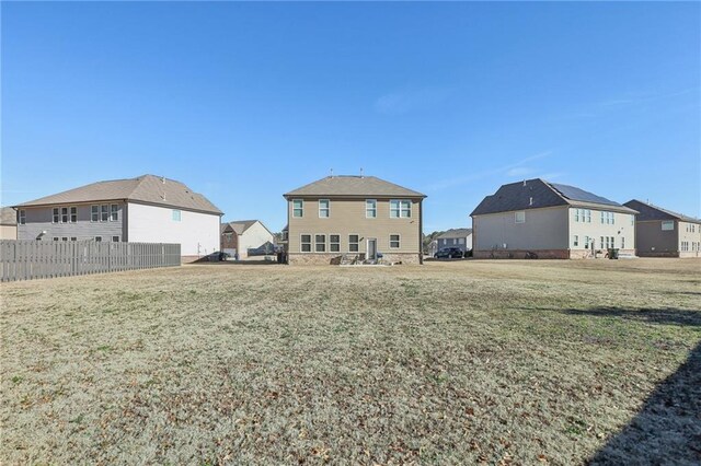 rear view of house featuring a lawn