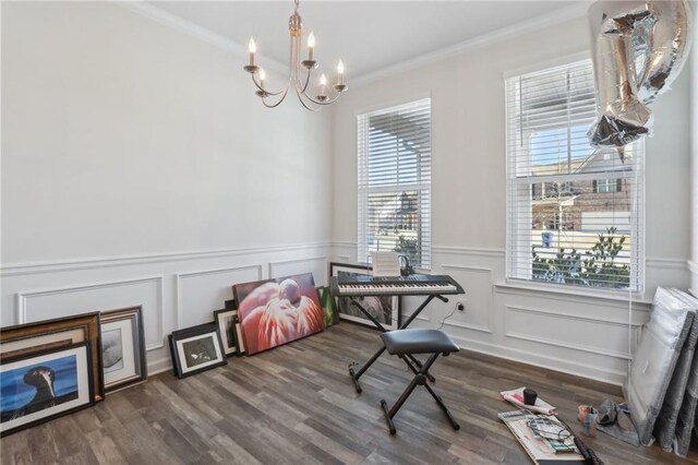 foyer entrance with dark hardwood / wood-style flooring, ornamental molding, and a chandelier