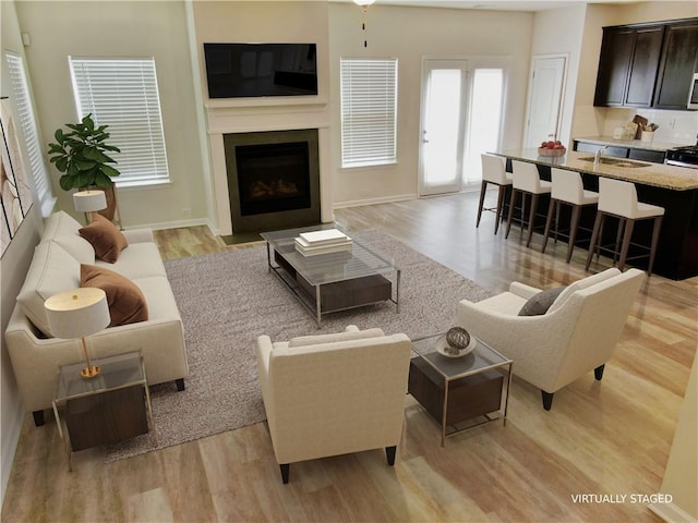 living room featuring light hardwood / wood-style floors and sink