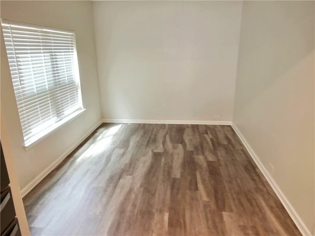 spare room featuring dark wood-type flooring