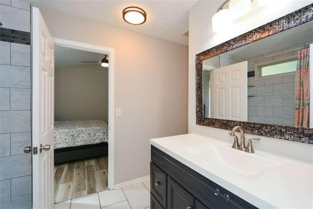 bathroom with a shower with shower curtain, ceiling fan, a textured ceiling, wood-type flooring, and vanity