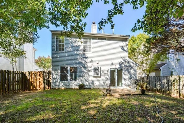 rear view of property with a patio and a yard