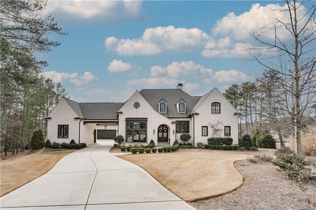 french provincial home featuring a garage