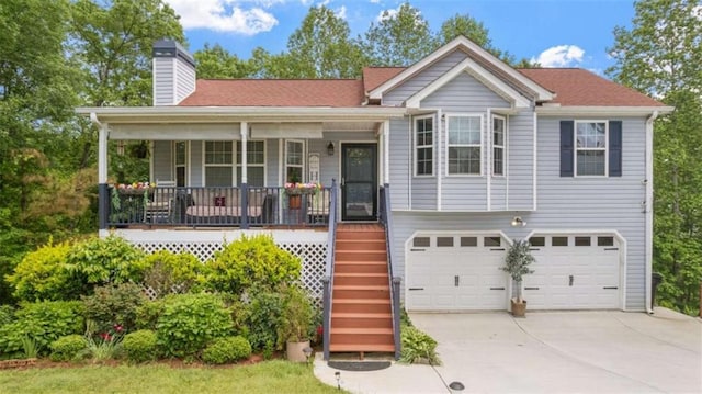 view of front of home featuring covered porch, a chimney, a garage, concrete driveway, and stairs