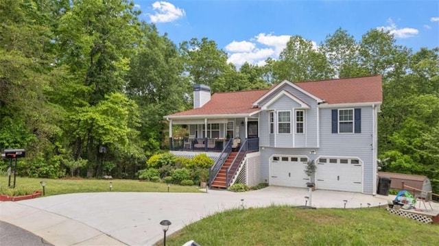 view of front of property with an attached garage, a chimney, concrete driveway, a porch, and stairway