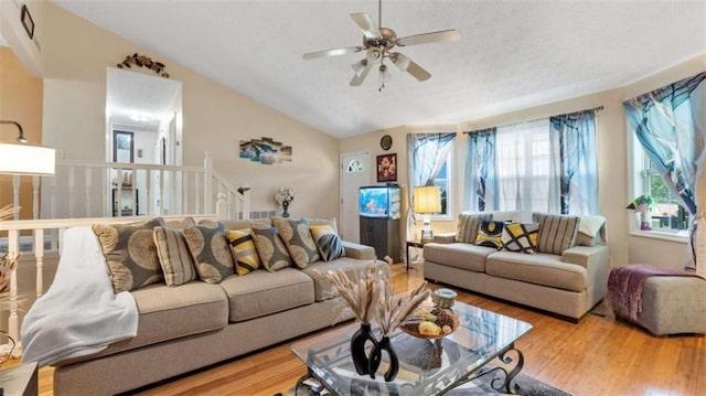 living area with ceiling fan, wood finished floors, and lofted ceiling