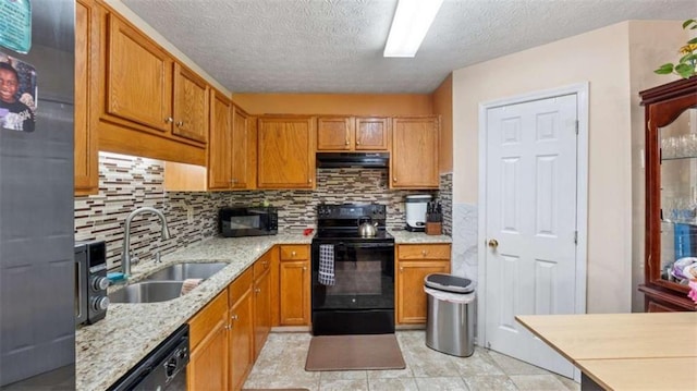 kitchen featuring decorative backsplash, a textured ceiling, a sink, black appliances, and extractor fan