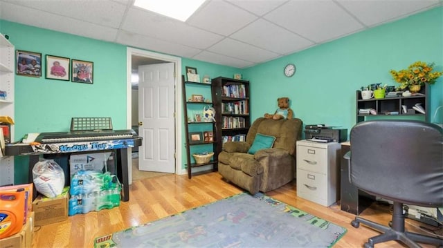 office space with a drop ceiling and wood finished floors