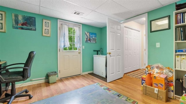 playroom with a drop ceiling and wood finished floors