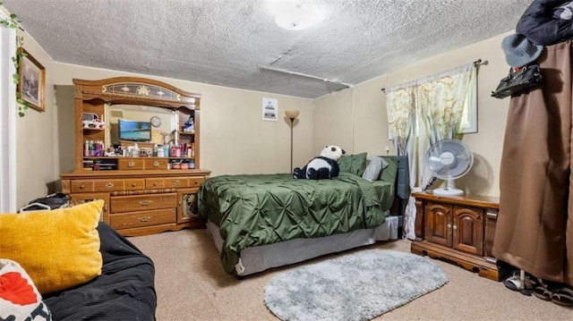 bedroom with carpet floors and a textured ceiling