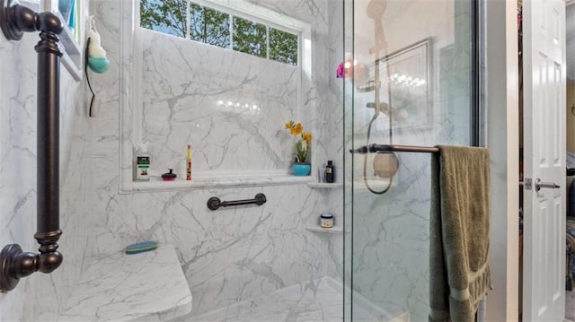 bathroom featuring a marble finish shower