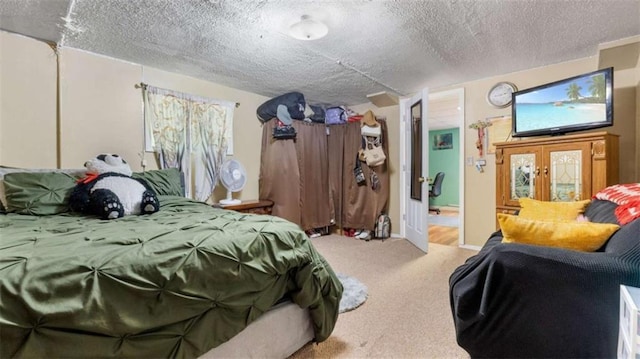 carpeted bedroom featuring a textured ceiling