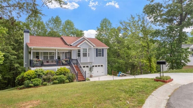 view of front of property featuring stairs, a chimney, an attached garage, and a front yard