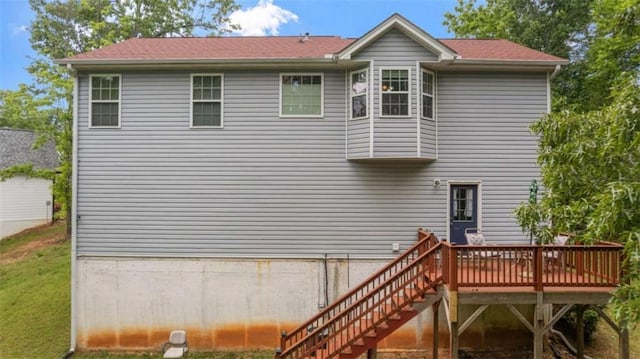 rear view of house with a wooden deck and stairway