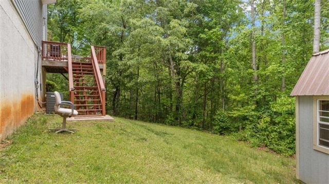 view of yard with stairs and a wooden deck
