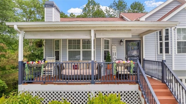 view of front of property featuring covered porch and a chimney