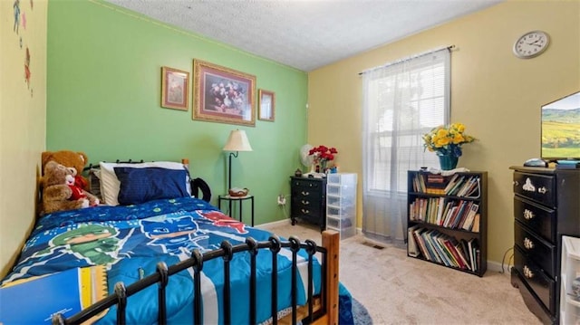 bedroom with baseboards, carpet, and a textured ceiling