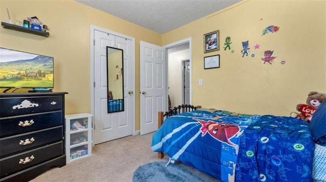 bedroom featuring carpet flooring and a textured ceiling