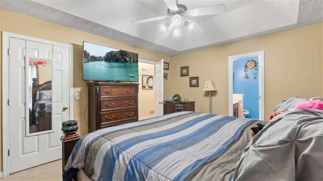 bedroom featuring carpet floors, ceiling fan, and ensuite bathroom
