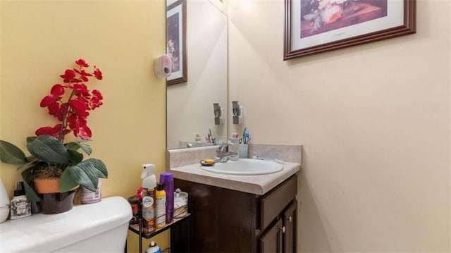 half bathroom with vanity and toilet