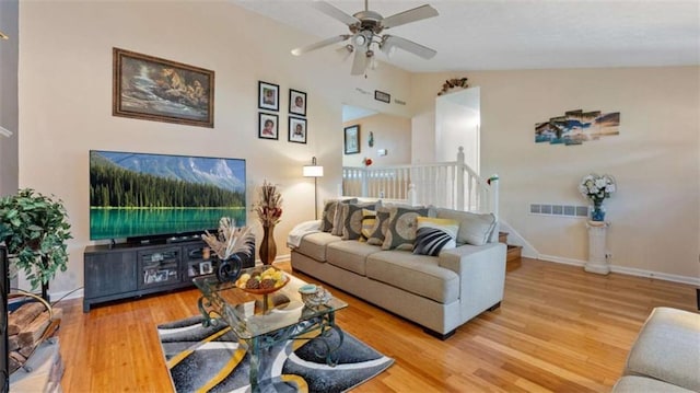 living room with ceiling fan, baseboards, wood finished floors, lofted ceiling, and visible vents