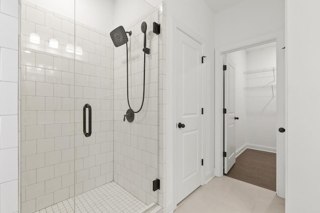 bathroom with tile patterned floors and walk in shower