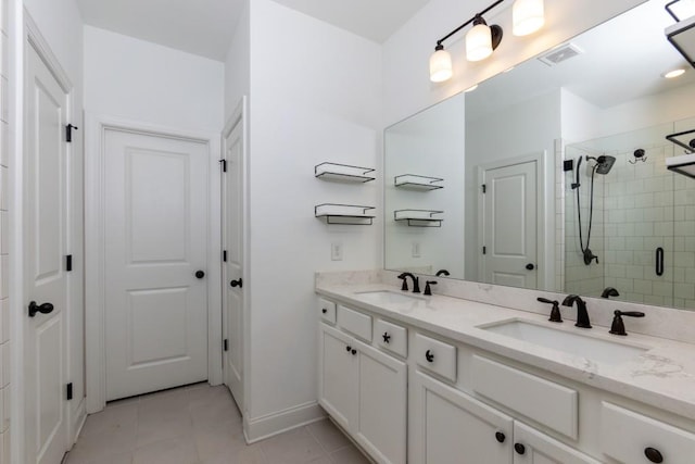 bathroom featuring tile patterned flooring, vanity, and an enclosed shower